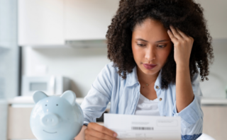 Woman looking at bill worried Struggling with Money What to Do