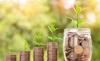 Growing stacks of coins representing trusting God with finances as a mom